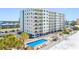 Beautiful condo building with a pool, beach access, and outdoor amenities at 13500 Gulf Blvd # 706, Madeira Beach, FL 33708