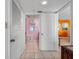 Hallway with tiled floor leading to bright rooms at 13500 Gulf Blvd # 706, Madeira Beach, FL 33708