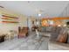 Open-concept living room with comfortable seating, tile flooring, and modern décor at 13500 Gulf Blvd # 706, Madeira Beach, FL 33708