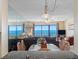 Bright living room featuring an ocean view and cozy furnishings at 13500 Gulf Blvd # 706, Madeira Beach, FL 33708