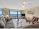 Comfortable living room with large windows overlooking ocean at 13500 Gulf Blvd # 706, Madeira Beach, FL 33708
