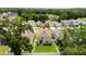 Aerial view showcases home's location among lush greenery and neighboring residences at 13727 Whiskey Daisy Dr, Dade City, FL 33525