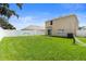 Spacious backyard with a white fence and manicured lawn offering a serene outdoor space at 13727 Whiskey Daisy Dr, Dade City, FL 33525