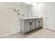 Bathroom showcasing a double sink vanity with grey cabinets, dark hardware, and neutral countertops at 13727 Whiskey Daisy Dr, Dade City, FL 33525