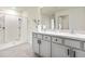 Bright bathroom with double vanity, spacious shower, and modern fixtures at 13727 Whiskey Daisy Dr, Dade City, FL 33525