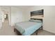 Cozy bedroom with a comfortable bed, artwork, and easy access to the hallway at 13727 Whiskey Daisy Dr, Dade City, FL 33525