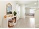 Inviting entryway featuring tile floors, and a decorative mirror on the wall above a white console table at 13727 Whiskey Daisy Dr, Dade City, FL 33525