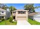 Charming two-story home with a well-maintained lawn and a two-car garage at 13727 Whiskey Daisy Dr, Dade City, FL 33525