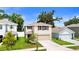 Beautiful home exterior featuring a well-manicured lawn and two-car garage at 13727 Whiskey Daisy Dr, Dade City, FL 33525