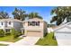 Lovely exterior of home with neutral paint, shutters, and two-car garage at 13727 Whiskey Daisy Dr, Dade City, FL 33525