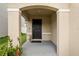 Inviting covered front porch with a decorative welcome mat and neutral colors at 13727 Whiskey Daisy Dr, Dade City, FL 33525
