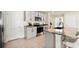 Bright, modern kitchen featuring stainless steel appliances, granite countertops, and a kitchen island with bar stool seating at 13727 Whiskey Daisy Dr, Dade City, FL 33525