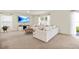 Spacious living room featuring a large sectional, a round coffee table, and natural light from nearby windows and a sliding glass door at 13727 Whiskey Daisy Dr, Dade City, FL 33525