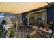 Back patio with sun-shade features seating, a grill, and a sliding glass door into home at 13920 Berkowitz Ave, Hudson, FL 34667