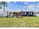 Spacious backyard with grass features a sun-shaded back patio and canal access on a bright day at 13920 Berkowitz Ave, Hudson, FL 34667