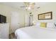 Bright bedroom with light walls, plank floors, and white furniture at 13920 Berkowitz Ave, Hudson, FL 34667