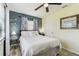Bright bedroom with plank floors, white bedding, and blue accent wall at 13920 Berkowitz Ave, Hudson, FL 34667