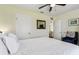 Bright bedroom features a comfortable king bed, a ceiling fan, and an ensuite opening at 13920 Berkowitz Ave, Hudson, FL 34667