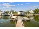 Picturesque dock on the canal provides waterfront access and stunning views of neighboring homes and boats at 13920 Berkowitz Ave, Hudson, FL 34667