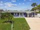 Charming single-story home with a well-kept lawn, mailbox and a welcoming front porch, exuding curb appeal at 13920 Berkowitz Ave, Hudson, FL 34667