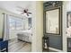 Hallway leading to bedroom, featuring light plank floors and decorative mirror and oars at 13920 Berkowitz Ave, Hudson, FL 34667