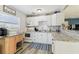 Bright kitchen with white cabinets, countertops, and appliances, a stylish design, and plenty of natural light at 13920 Berkowitz Ave, Hudson, FL 34667