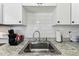 Close-up of the kitchen sink area, featuring stainless steel fixtures and ample counter space at 13920 Berkowitz Ave, Hudson, FL 34667