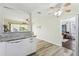 Clean white kitchen features dishwasher, light countertops, and is adjacent to a bright dining room at 13920 Berkowitz Ave, Hudson, FL 34667