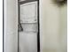 Laundry closet contains a stacked washer and dryer with a white vented door at 13920 Berkowitz Ave, Hudson, FL 34667