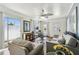 Bright living room with wood-look floors, comfortable seating, and sliding doors leading to an outdoor area at 13920 Berkowitz Ave, Hudson, FL 34667