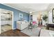 Inviting living room featuring wood floors, comfortable seating, and a view into a modern kitchen and bathroom at 13920 Berkowitz Ave, Hudson, FL 34667