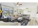 Bright living room featuring two couches, a glass coffee table, and views of the outside scenery at 13920 Berkowitz Ave, Hudson, FL 34667