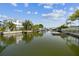 Wide canal view showcasing multiple docks and beautiful waterfront homes under a sunny sky, perfect for boating enthusiasts at 13920 Berkowitz Ave, Hudson, FL 34667