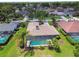 Aerial view of a home featuring a private screened-in pool and lush landscaping at 14170 Fennsbury Dr, Tampa, FL 33624