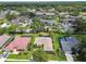 Aerial view showcasing a residential area with houses, a lake, condos, and pools at 14170 Fennsbury Dr, Tampa, FL 33624