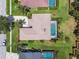 Overhead view featuring a well-manicured lawn, driveway, and a screened-in pool with lush landscaping at 14170 Fennsbury Dr, Tampa, FL 33624