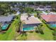 Aerial view of a home featuring a private screened-in pool and lush landscaping at 14170 Fennsbury Dr, Tampa, FL 33624