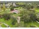 An aerial view of the tennis courts, surrounded by a playground and lush green space at 14170 Fennsbury Dr, Tampa, FL 33624