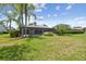 Expansive backyard with lush green grass and screened-in patio, perfect for outdoor entertaining at 14170 Fennsbury Dr, Tampa, FL 33624