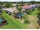 Aerial view showcasing a beautiful backyard with a pool, tropical landscaping, and lush green grass at 14170 Fennsbury Dr, Tampa, FL 33624