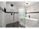 Modern bathroom with a standalone tub, shower, unique lighting, and beautiful tile work at 14170 Fennsbury Dr, Tampa, FL 33624