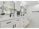 Contemporary bathroom with double sinks, white cabinets, and black hardware at 14170 Fennsbury Dr, Tampa, FL 33624