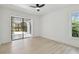 A bright bedroom features light wood flooring, and a sliding door to a screened patio at 14170 Fennsbury Dr, Tampa, FL 33624