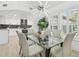 Dining room with a modern light fixture, adjacent to the kitchen and featuring plantation shutters at 14170 Fennsbury Dr, Tampa, FL 33624