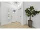 Welcoming entryway with a modern door, sidelight window, and wood-look flooring at 14170 Fennsbury Dr, Tampa, FL 33624