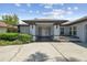 Stylish home exterior showcasing modern design, covered entrance and meticulously maintained landscaping at 14170 Fennsbury Dr, Tampa, FL 33624