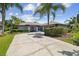 A well landscaped home with a light grey exterior and grey accents and a large driveway at 14170 Fennsbury Dr, Tampa, FL 33624