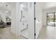 Hallway view of half bathroom with modern fixtures leading to bright, open-concept living spaces at 14170 Fennsbury Dr, Tampa, FL 33624