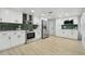 Well-lit kitchen featuring white cabinets, stainless steel appliances, and a green tile backsplash at 14170 Fennsbury Dr, Tampa, FL 33624
