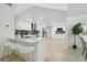 Spacious kitchen with a breakfast bar, white cabinetry, green subway tile backsplash, and stainless steel appliances at 14170 Fennsbury Dr, Tampa, FL 33624